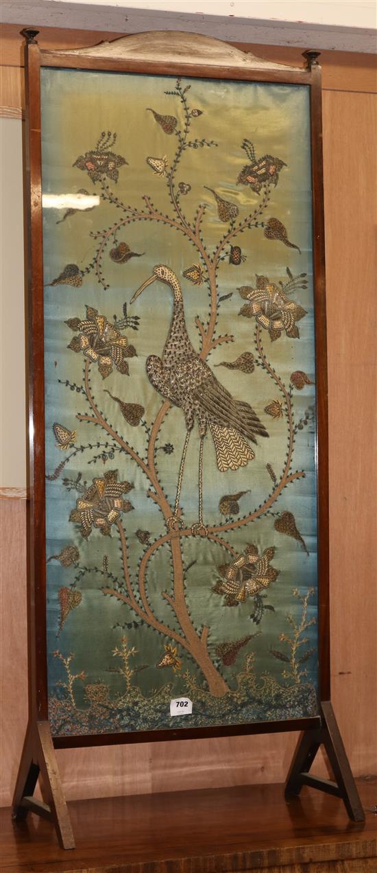 A silver threadwork panel firescreen